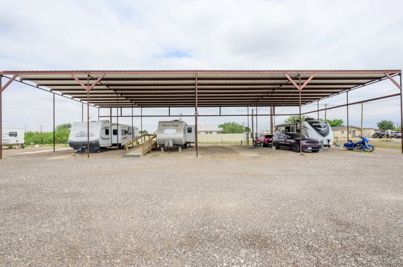The steel carport over the four covered spots
