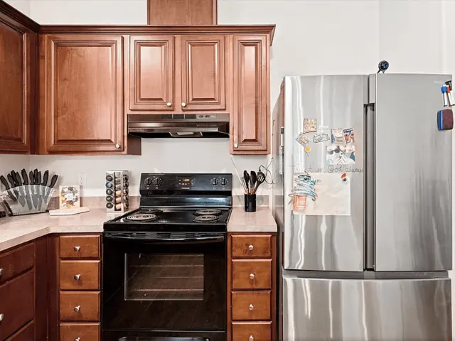 Kitchen: stainless refrigerator and range